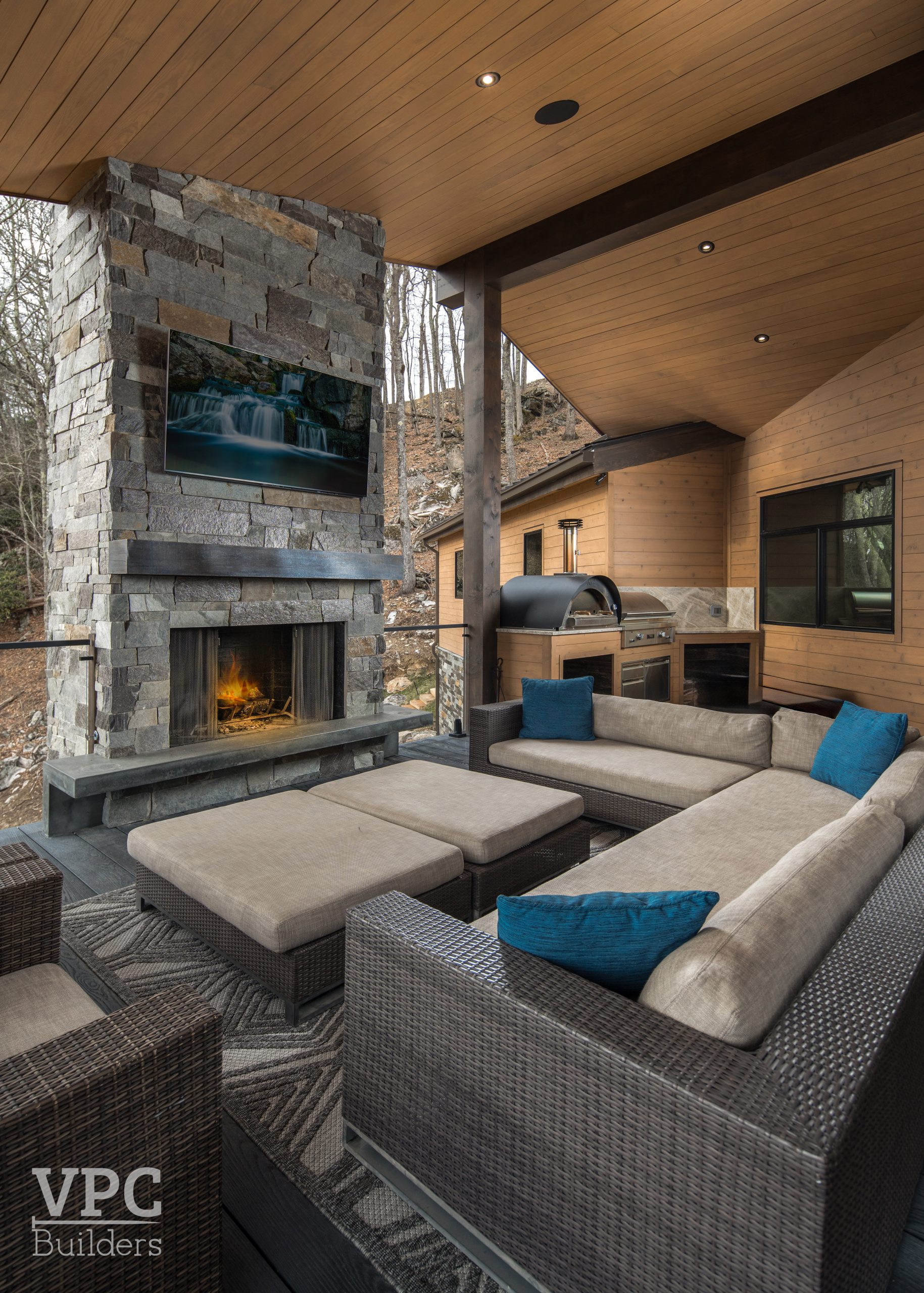 patio seating area and outdoor kitchen with grill and pizza oven