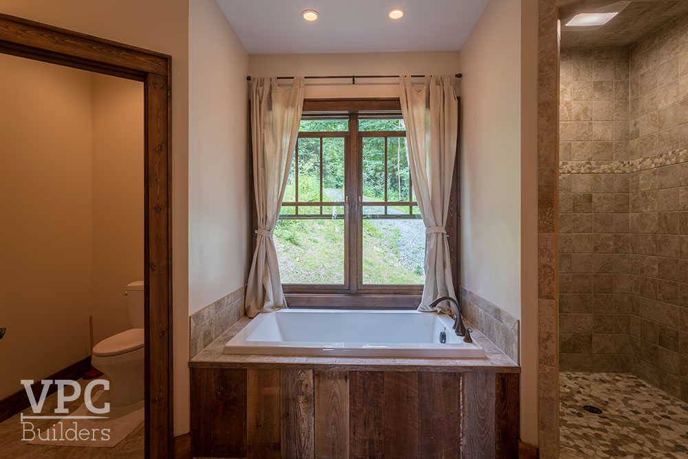 Rustic Retreat bathroom with tub, shower, and private toilet