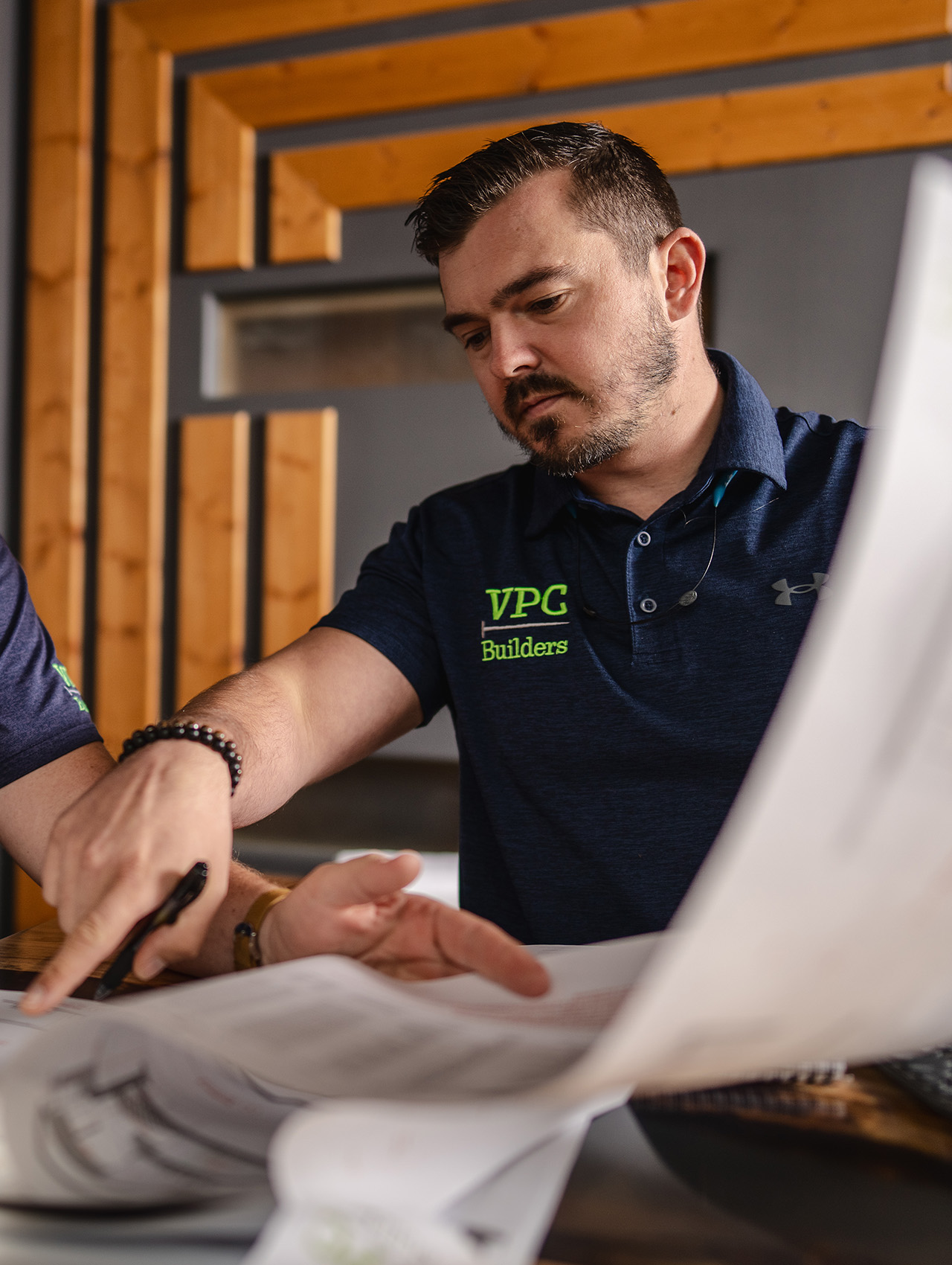 VPC designer reviewing plans and pointing