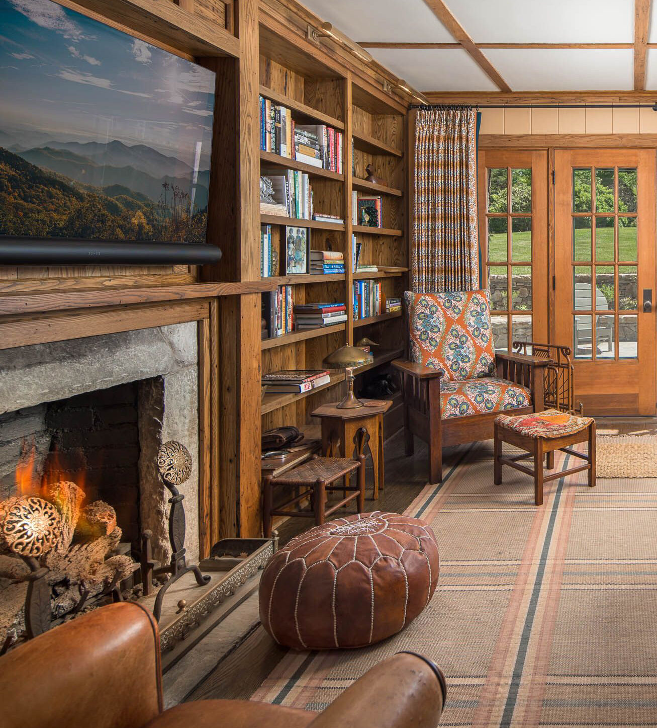 Cottage style library with fireplace and french doors.