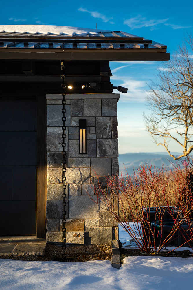 stone pillar with rain chain in winter overlooking the mountain range