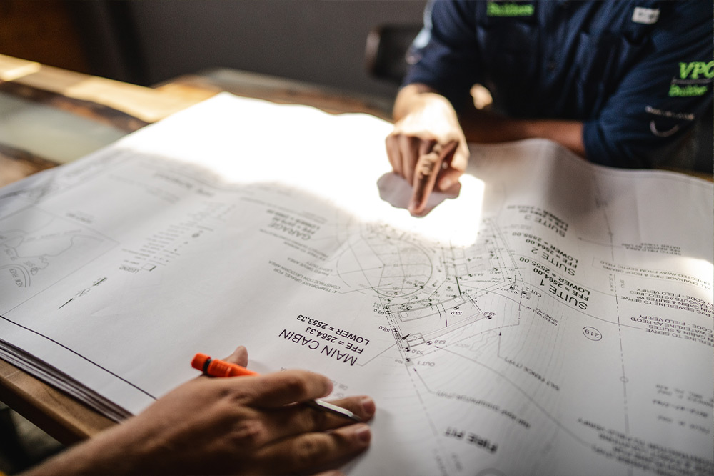 Two people reviewing site plans for an upcoming projects.