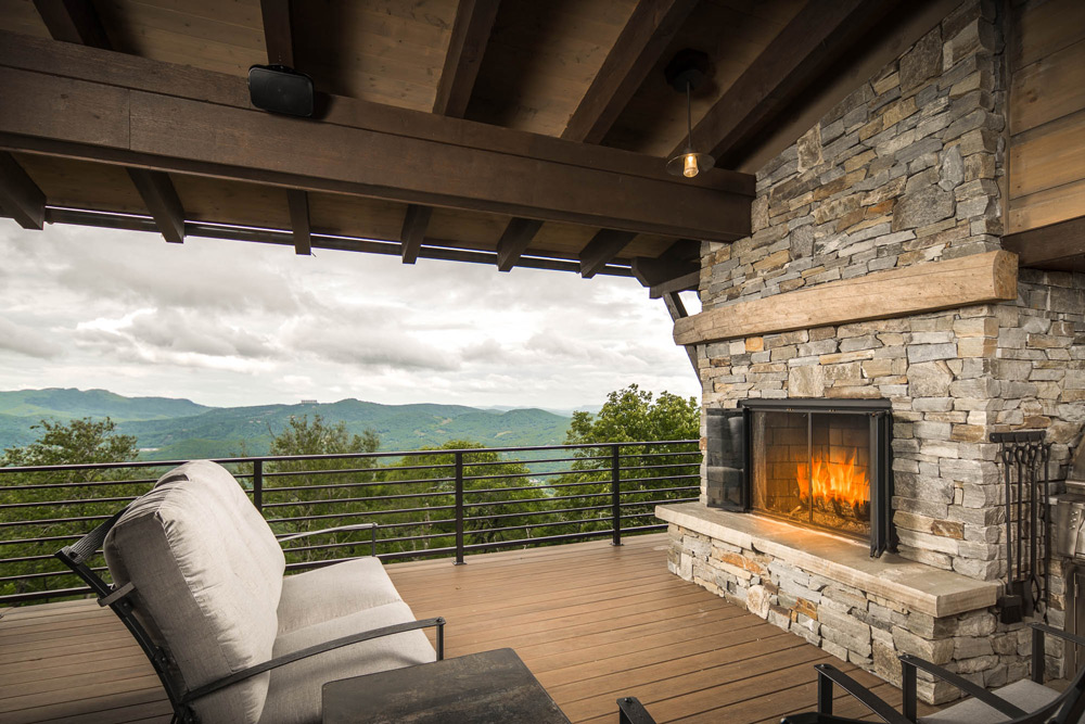 Outdoor patio with custom fireplace overlooking the mountains.