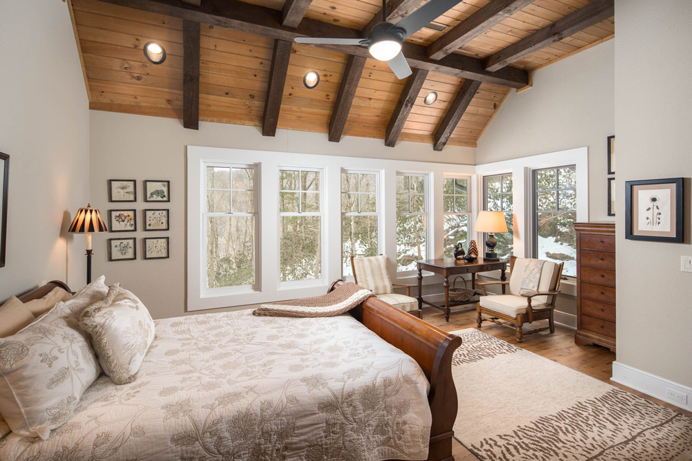 Master bedroom with cathedral ceilings and sitting area.