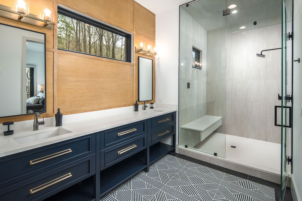 Bathroom remodel with double vanity and walk in shower complete with bench and waterfall shower head.